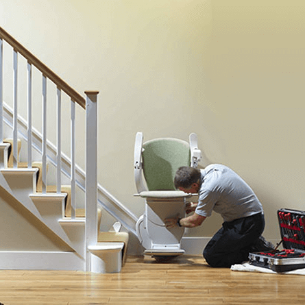 brooklyn stairlift repairs - repairman working on straight stairlift - square cropped